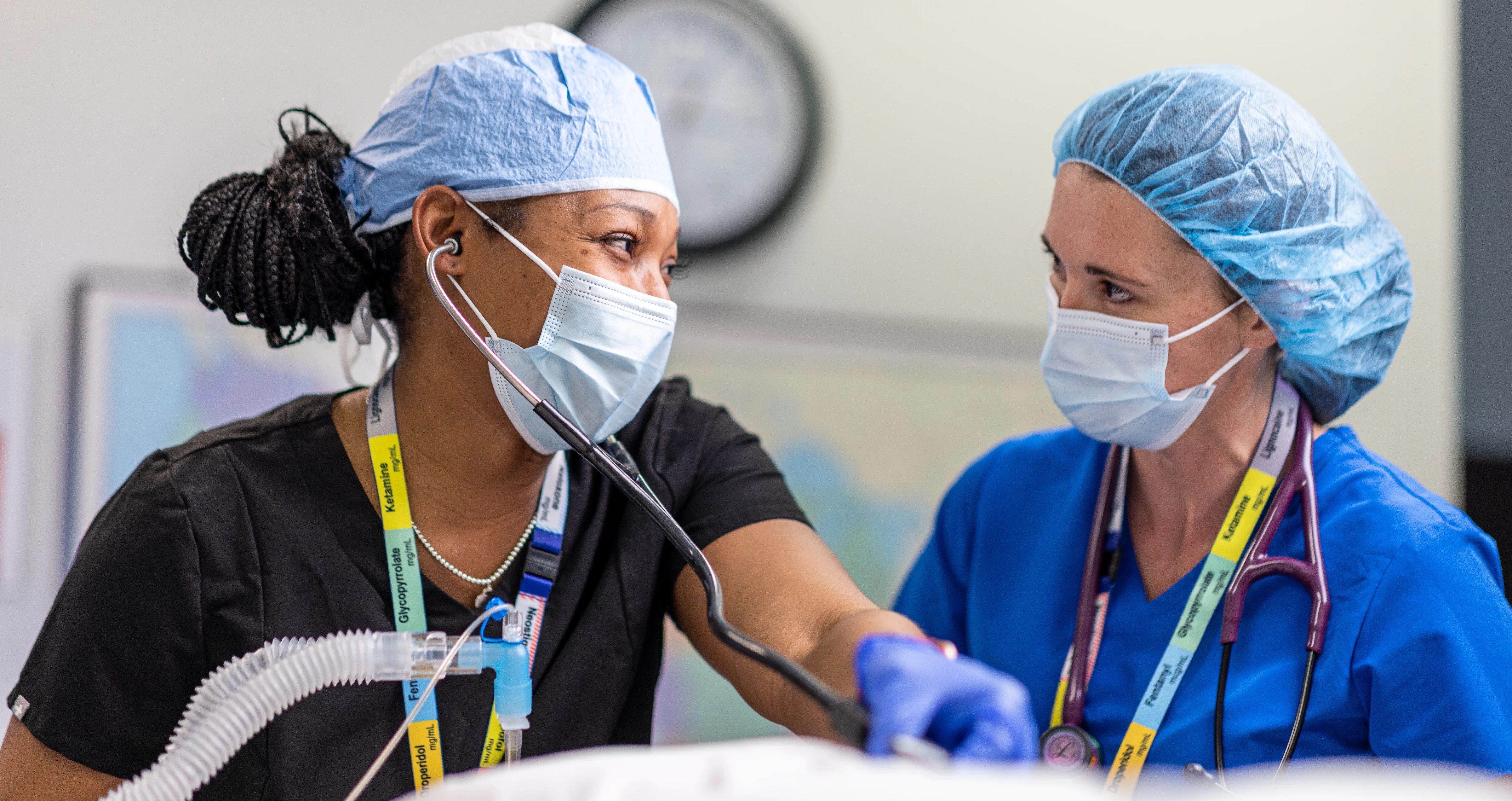 Nurse anesthesia students work together in lab.