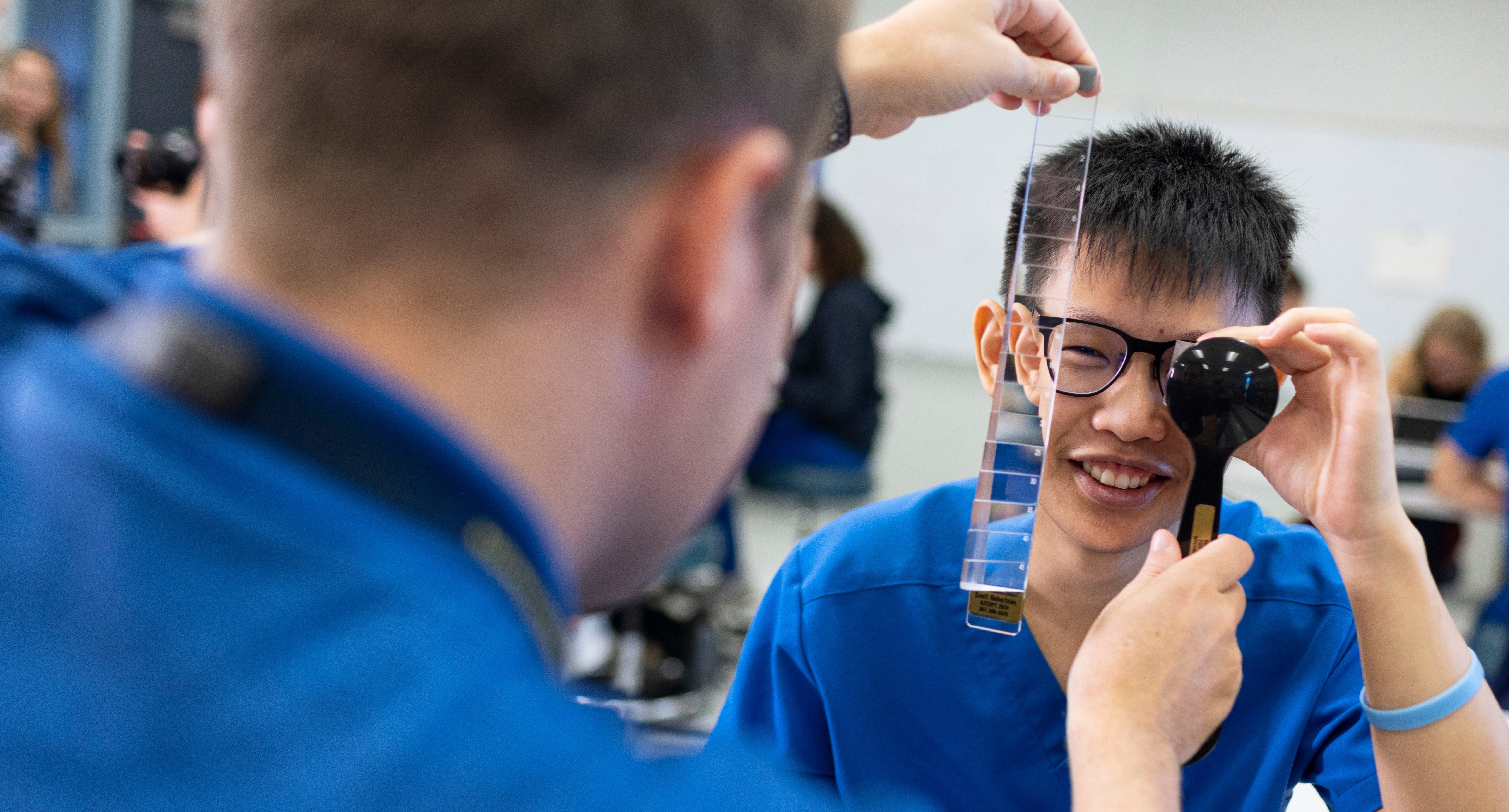 Optometry students work together in lab